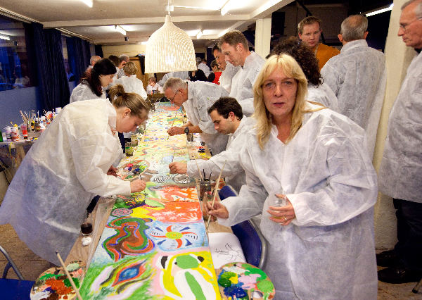 \"Bij Kunstwerk in de Piersonstraat wordt vanmiddag een workshop gehouden voor 100 man van het bedrijf Geering Plough.Zij schilderen gezamenlijk aan een groot schilderij van vier meter en daarnaast moeten er nog negen kleinere schilderijen gemaakt worden. Komen bij het bedrijf te hangen.\"